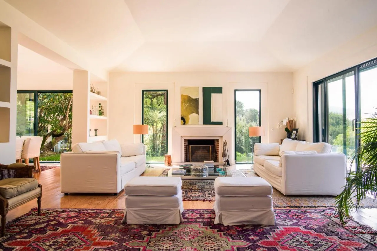 Living room with fireplace and garden views at Villa Rio Seco